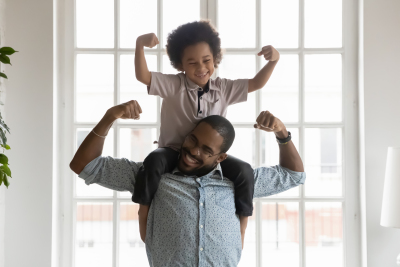 parent with child sitting on his shoulders