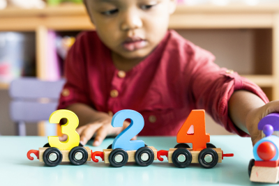 child playing with number toys