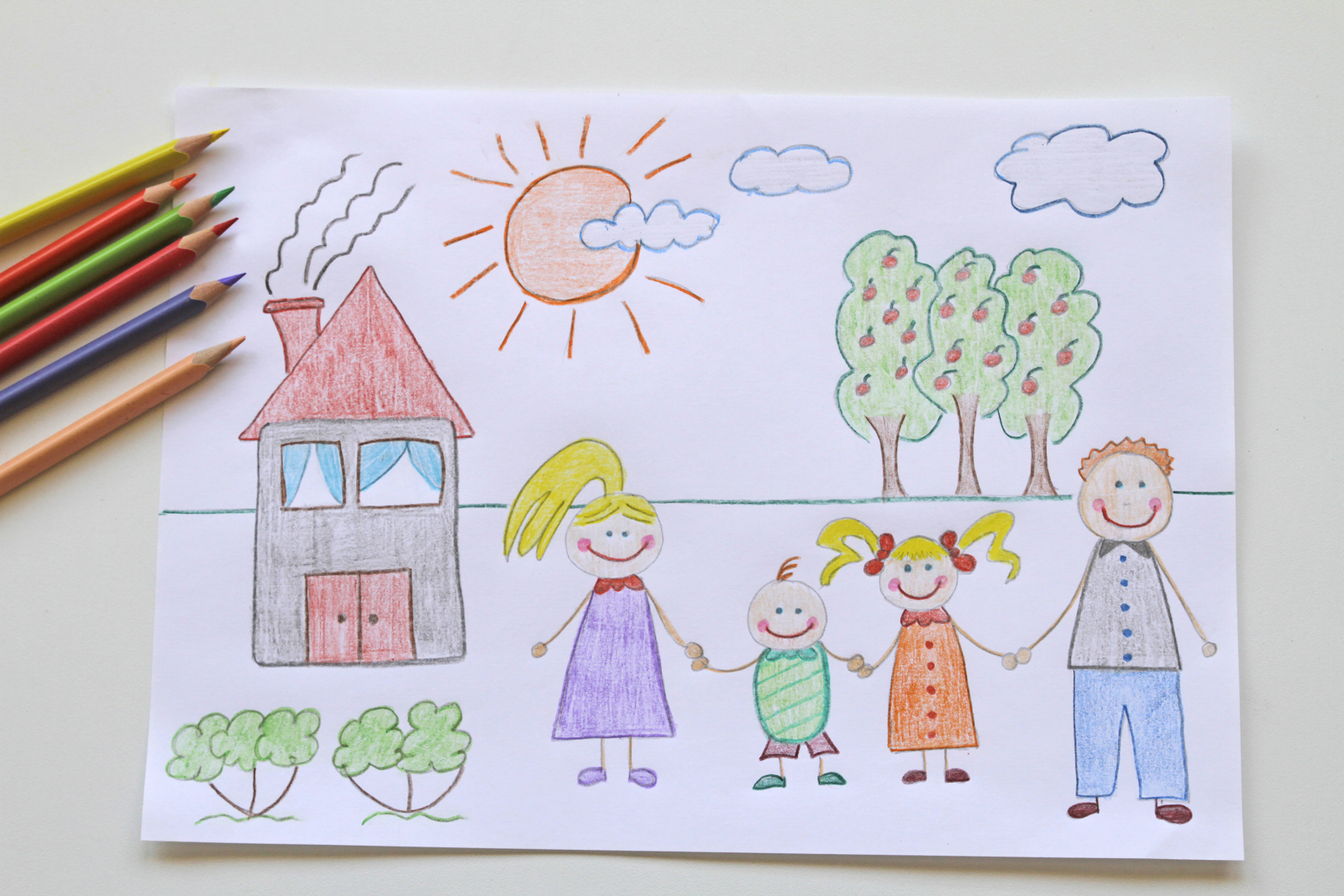 crayon drawing of a family in front of a house