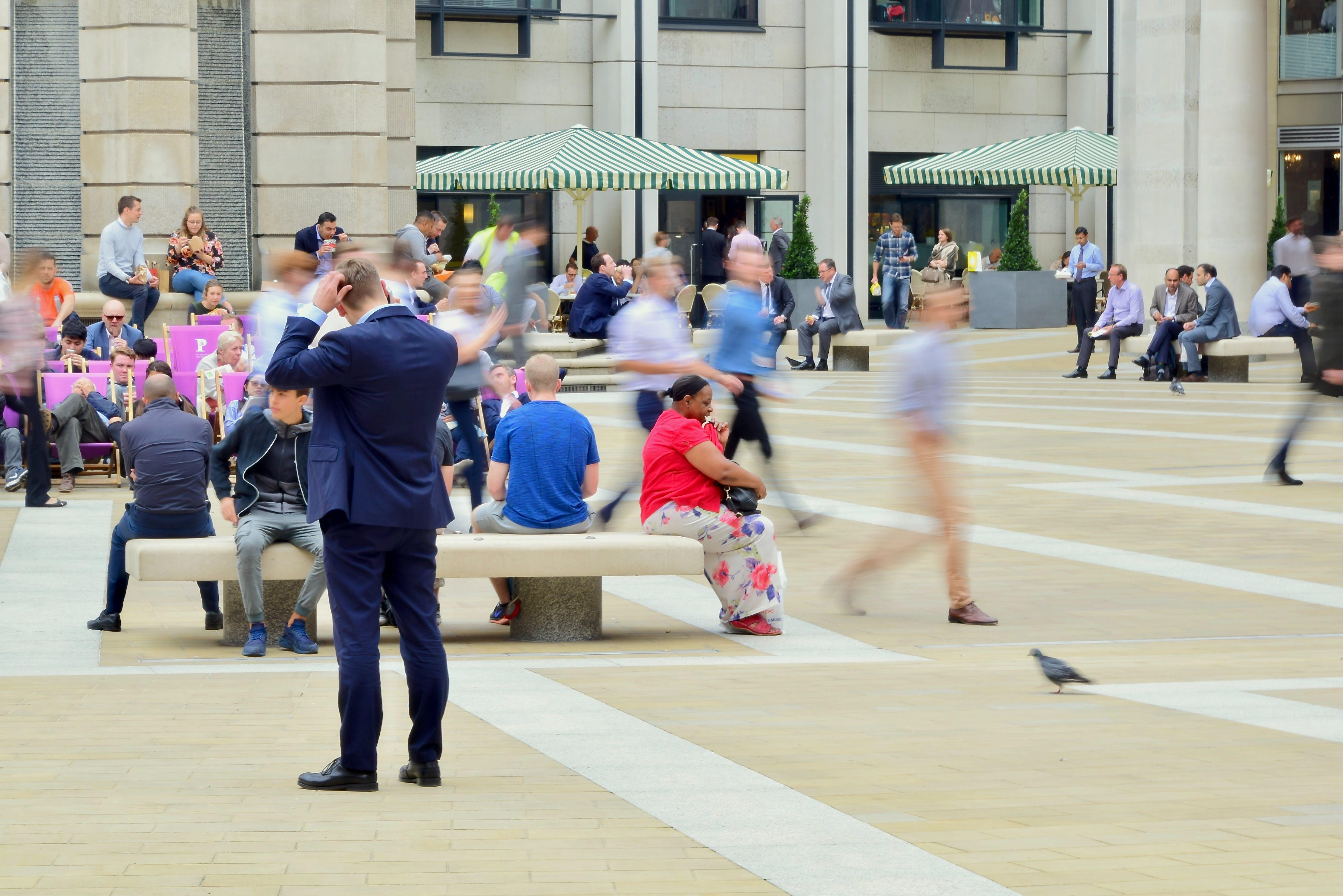 man stood alone in a square unsure of where to go or what to do
