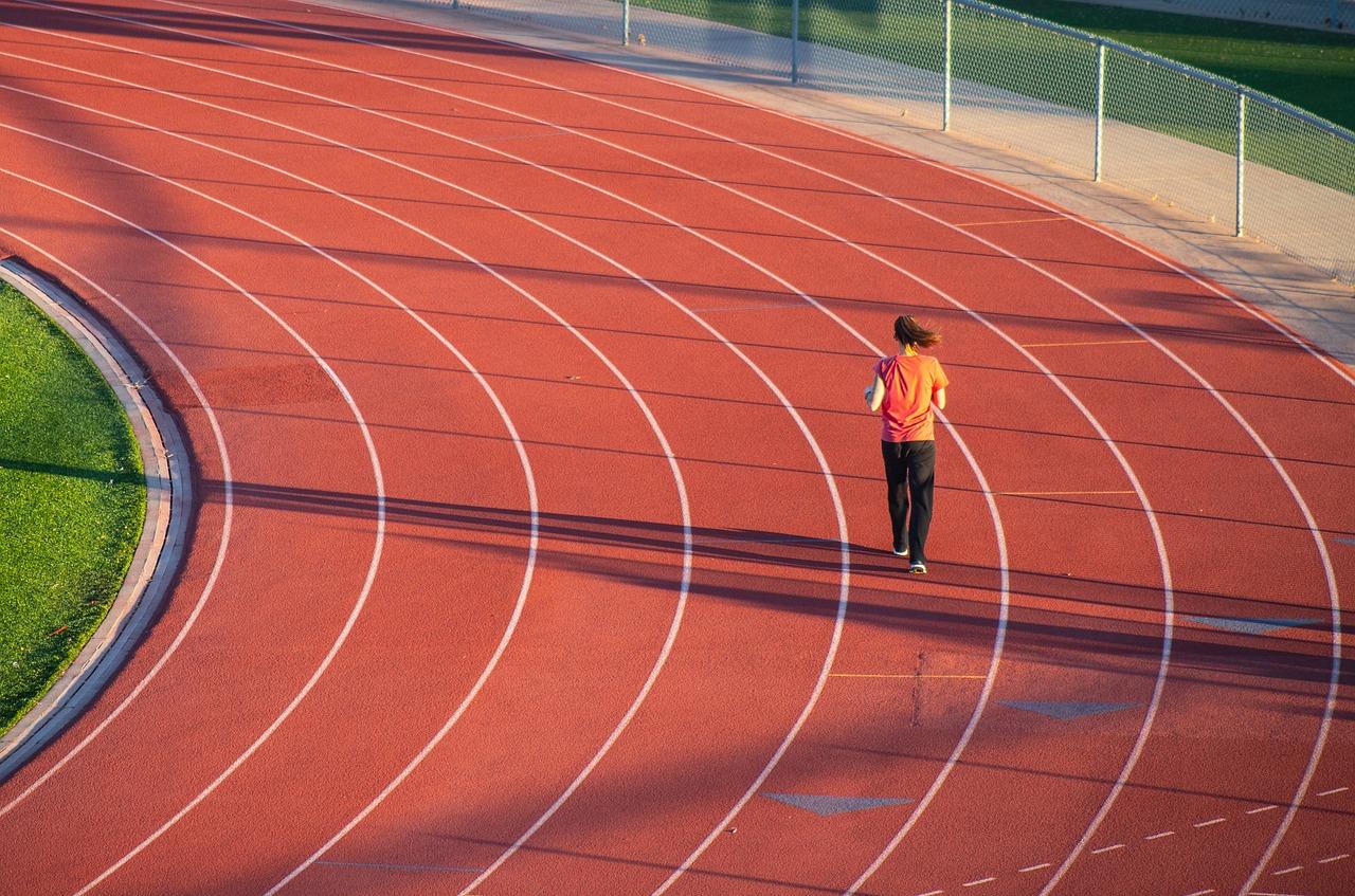 woman running on a running track