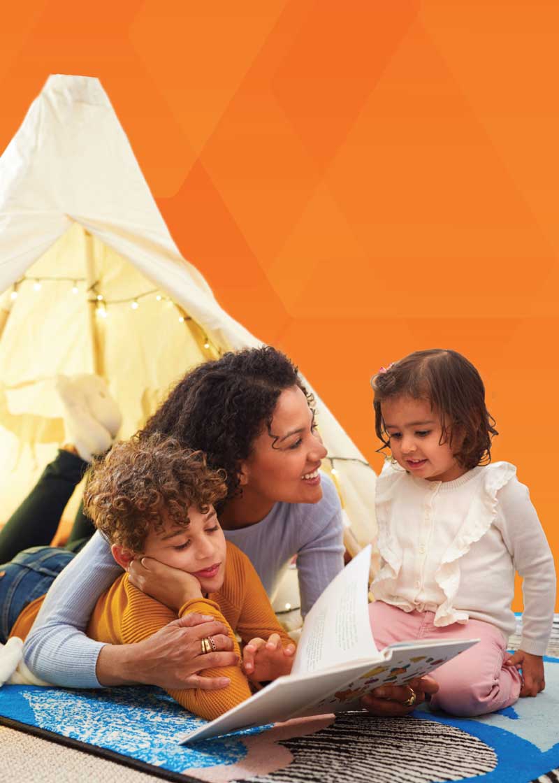 children and woman lying on the floor playing